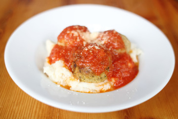 Meatballs with marinara sauce and polenta.