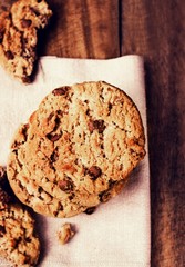 Chocolate cookies on white linen napkin on wooden