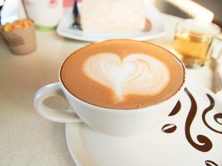 Cup of coffee with heart pattern in a white cup
