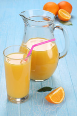 Glass and jug of orange juice
