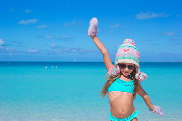 Fototapeta na wymiar Adorable happy little girl having fun on tropical beach