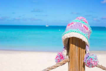 Closeup warm knitted cap on fence at tropical beach