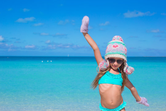Adorable happy little girl having fun on tropical beach