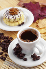 Cup of coffee and round cake