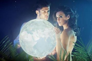 Stoff pro Meter Conceptual photo of the couple holding the Earth © konradbak