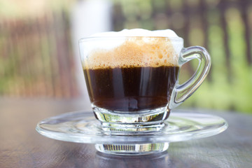 Hot  espresso with milk and foam in cup.
