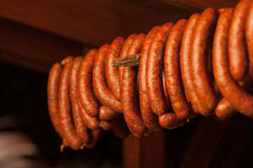 Traditional food. Smoked sausuages in smokehouse.