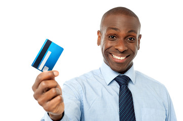 Cheerful executive holding credit card