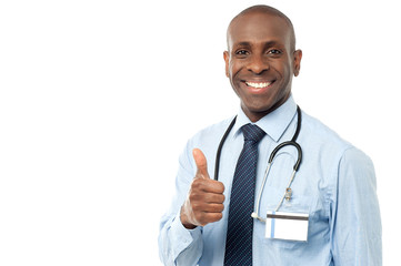 Smiling medical doctor showing thumbs up