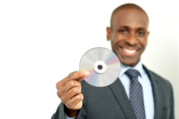 Handsome businessman holding a cd