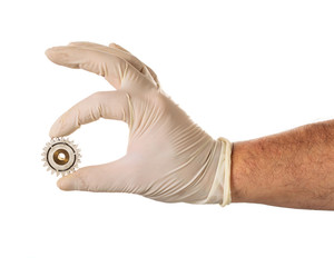 Hand in latex glove with used gear