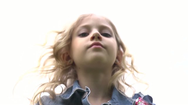 Face of a little girl with ringlets of hair falling down