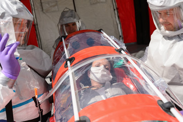 HAZMAT team with patient on stretcher