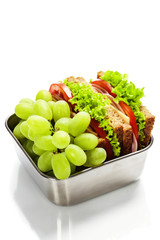 Lunch box with sandwich and grapes
