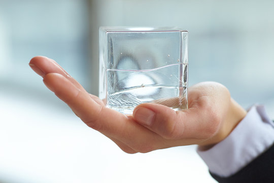 glass cube in the hand