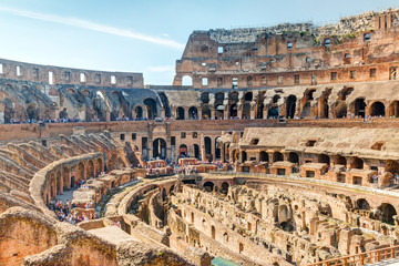 Inside famous Colosseum or Coliseum in Rome, Italy. Panorama of ruined arena and tribunes.