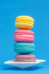 Sweet and colourful french macaroons on background