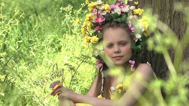 Little girl in a wreath poses for the camera