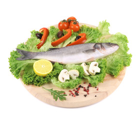 Fresh seabass on platter with lettuce.