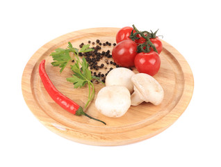 Vegetables on wooden platter.