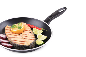 Frying pan with salmon steak.