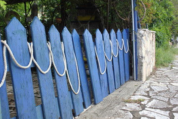 Ramshackle blue painted wooded gates and fence