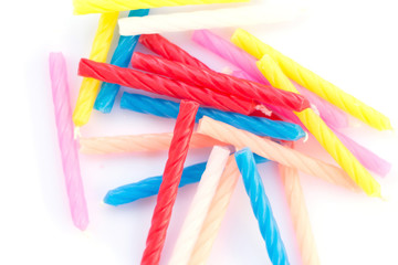 Colorful birthday candles on white background.