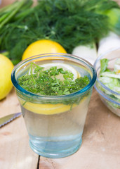 glass of fresh detoxing lemonade with parsley