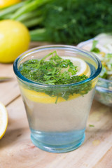 glass of fresh detoxing lemonade with parsley