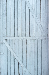 old, colored paint, cracked wooden door with diagonal slats