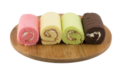 Colorful roll cake on wooden plate
