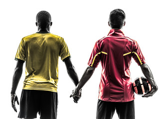 Fototapeta premium two men soccer player standing holding hands silhouette