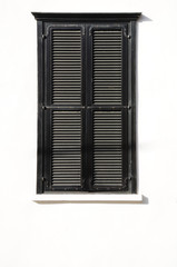 Window of a house closed with wooden shutters . Tel Aviv.