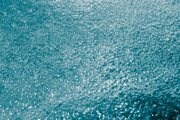 blue bubbling water from beneath the waves