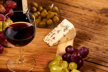 A red glass of wine and cheese