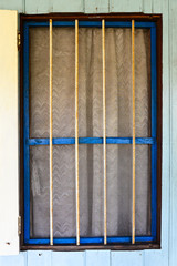 Old rusty blue frame window