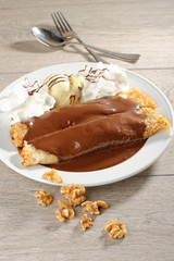 close up of two french style crepes, served with chocolate