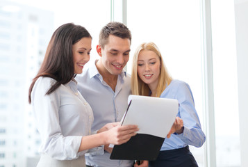 business team looking at clipboard