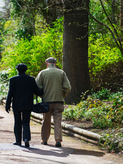 senior couple taking a walk in a park while holding hands