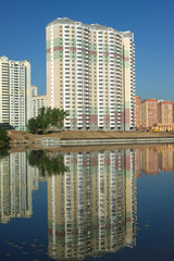 New buildings over river and clear blue sky in summer day