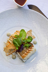 Piece of cod, vegetable noodles, toast and salad