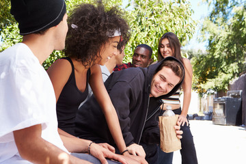 Gang Of Young People In Urban Setting Drinking Alcohol