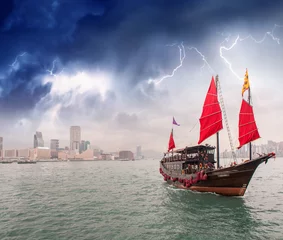 Foto op Canvas Sailing ship crossing the sea near a city during a storm © jovannig
