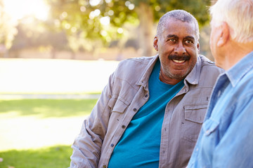 Two Senior Men Talking Outdoors Together