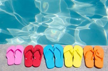 Color flip flops by the pool - 65259927