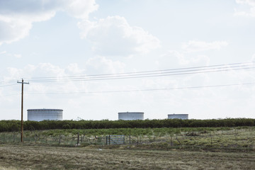 Feild with three water tanks in Texas