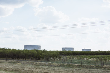 Feild with three water tanks in Texas