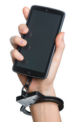 Mobile phone addiction concept. Smartphone and handcuff in hand