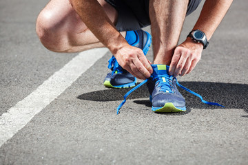Runner trying running shoes getting ready for run.