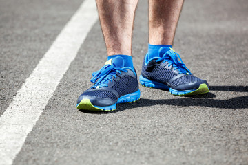 Fototapeta na wymiar Closeup of a male runner standing - Fitness concept.